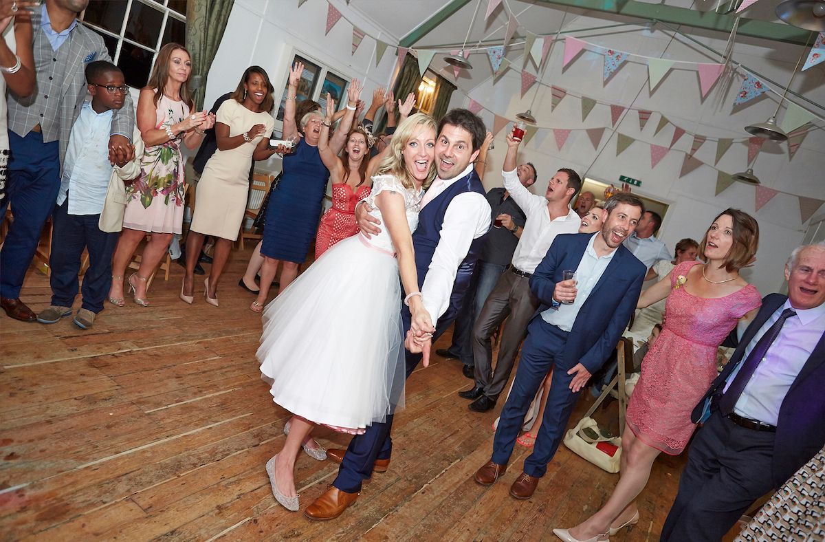 happy guests dancing at a wedding with the rockpins
