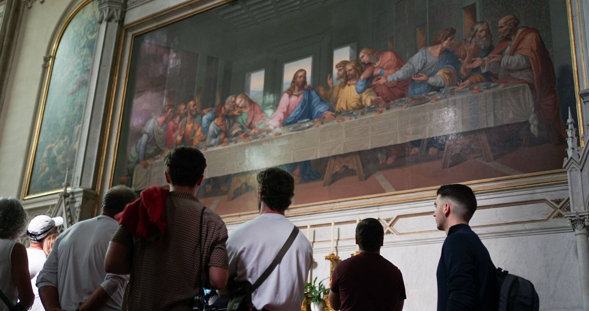 Visitors viewing the Last Supper mosaic in Minoritenkirche during Vienna walking tour