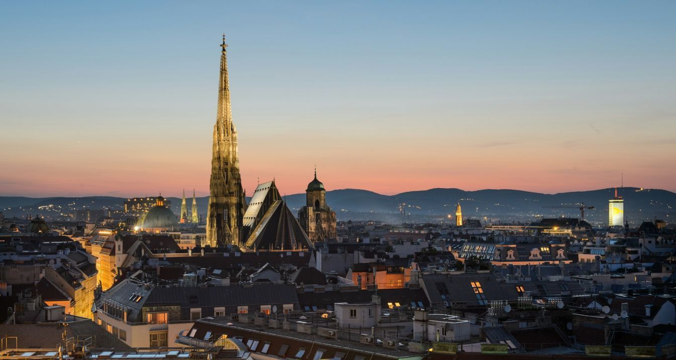 St. Stephen’s Cathedral and Vienna skyline at dusk Vienna skyline at sunset with St. Stephen’s Cathedral – First time in Vienna travel guide