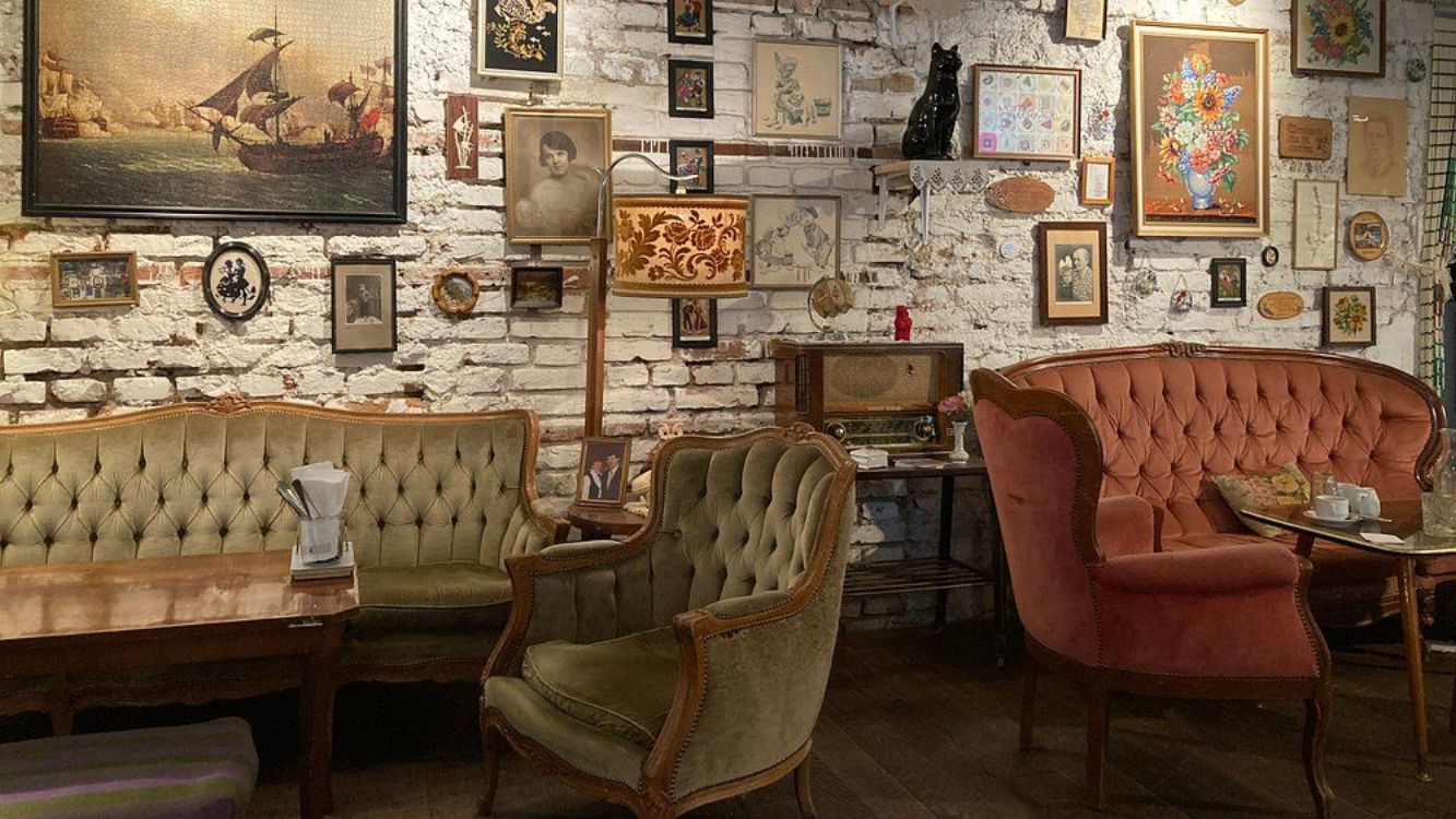 Retro-style interior of Café Vollpension in Vienna with vintage furniture and wall art