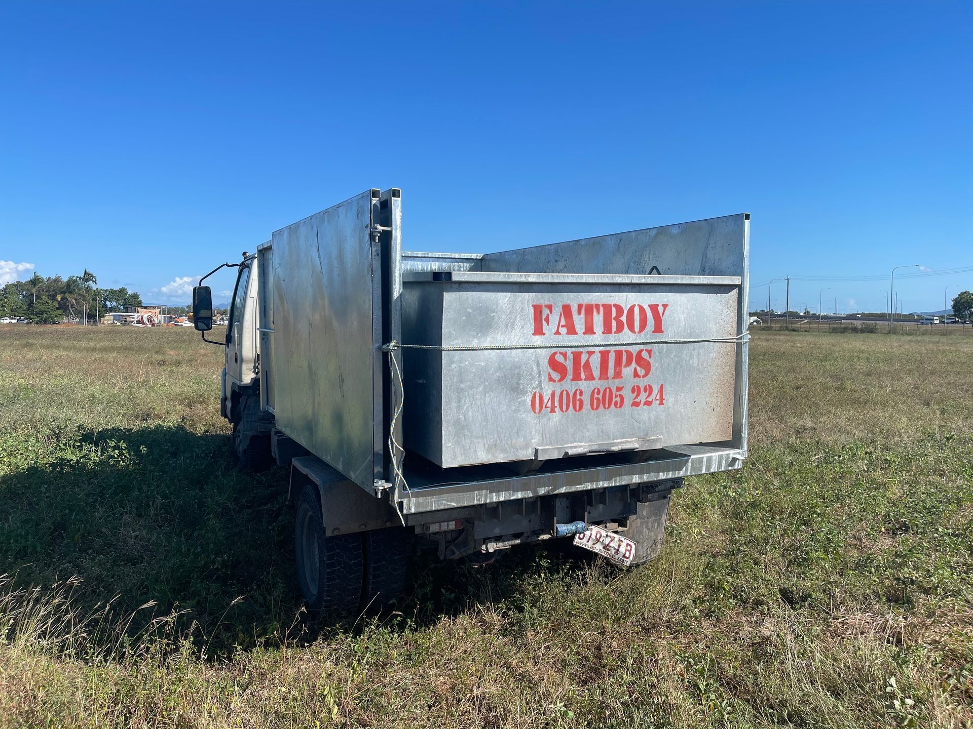 Rear View of a Dump Truck in a Field — Fat Boy Skips Townsville In Nome, QLD