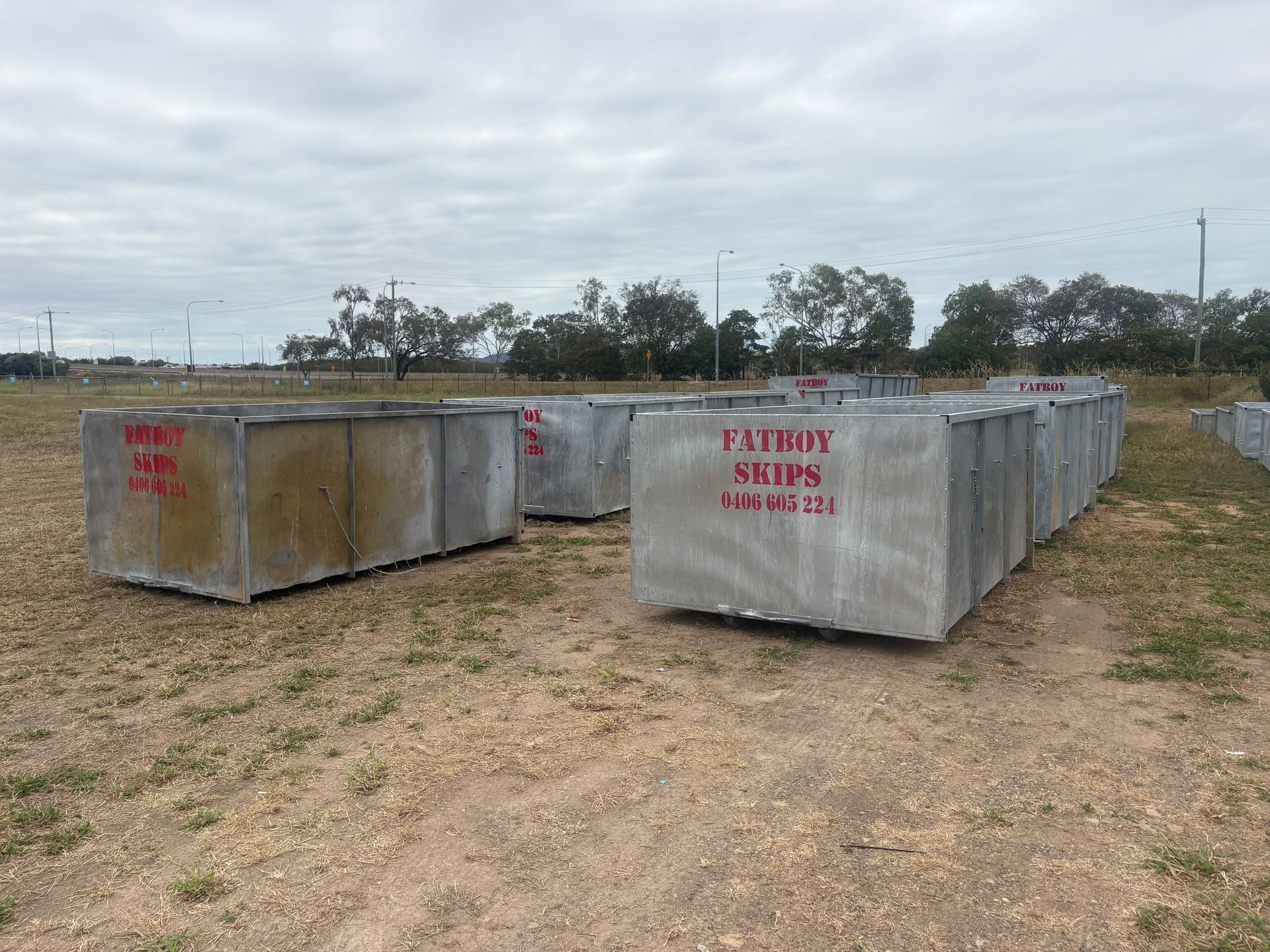 A Rusty Dumpster Filled with Broken Red Bricks and Concrete Debris — Fat Boy Skips Townsville In Nome, QLD