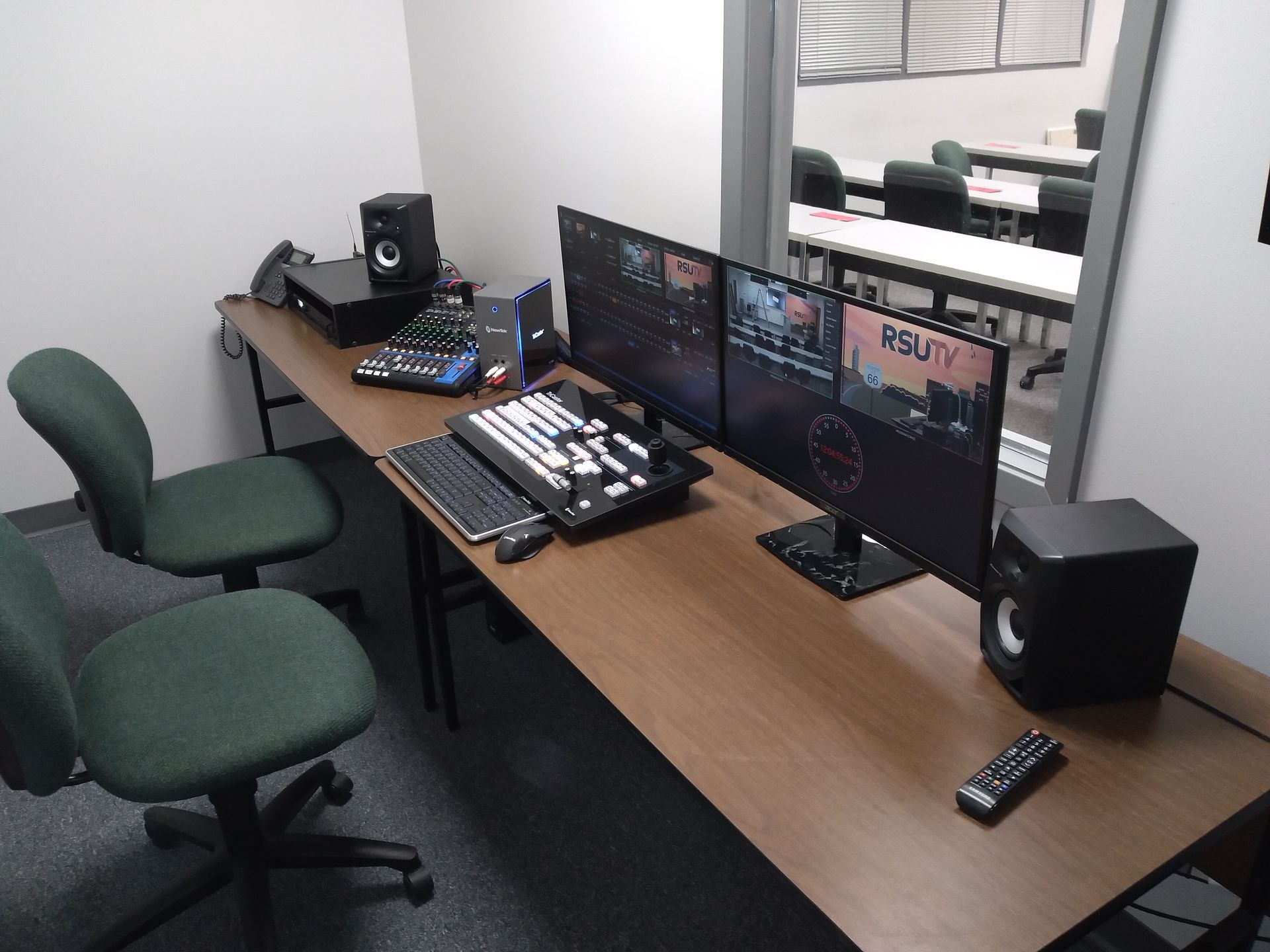 A desk with two monitors and a keyboard on it