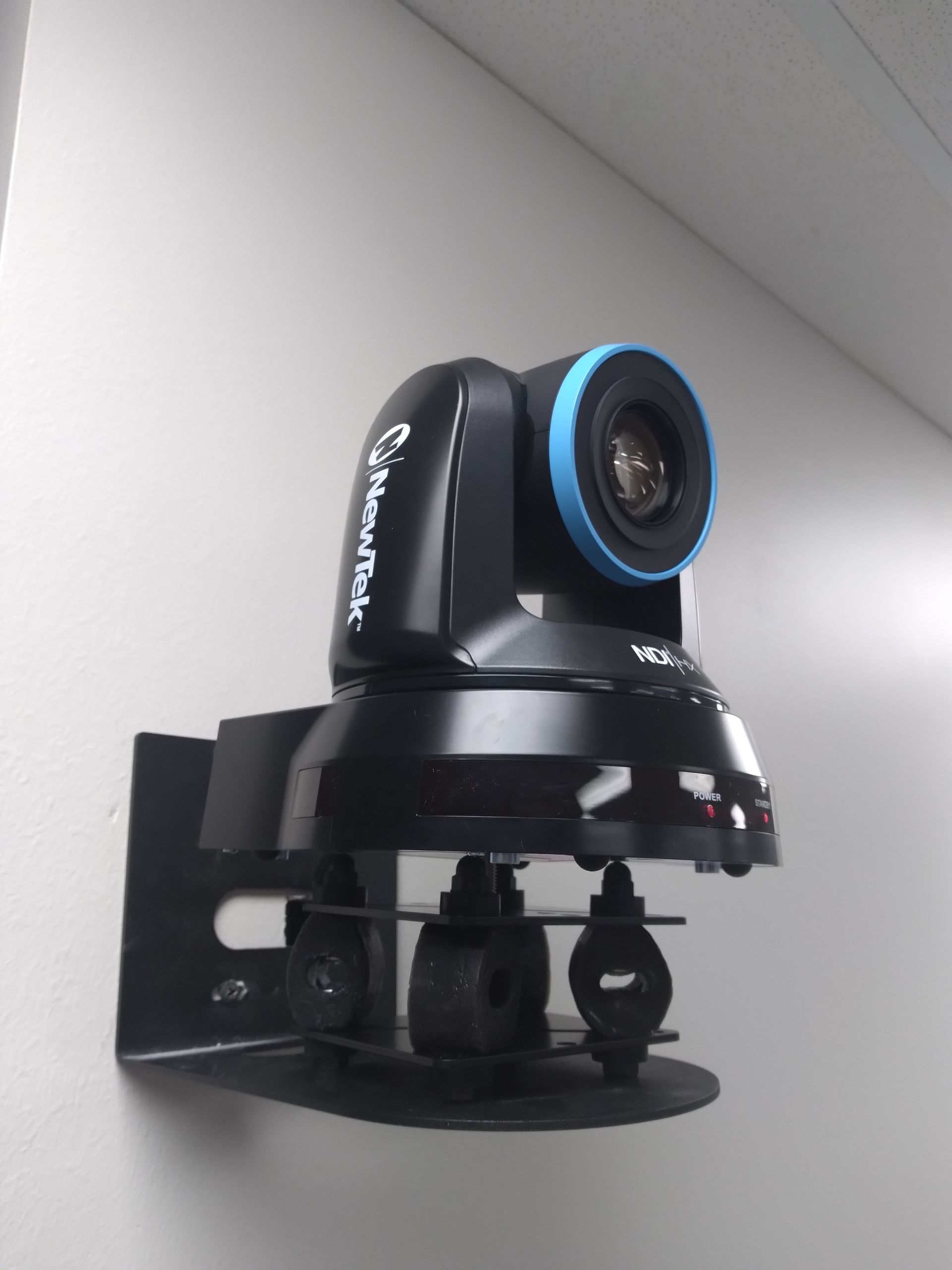 A camera mounted on a wall that says cybertek on it