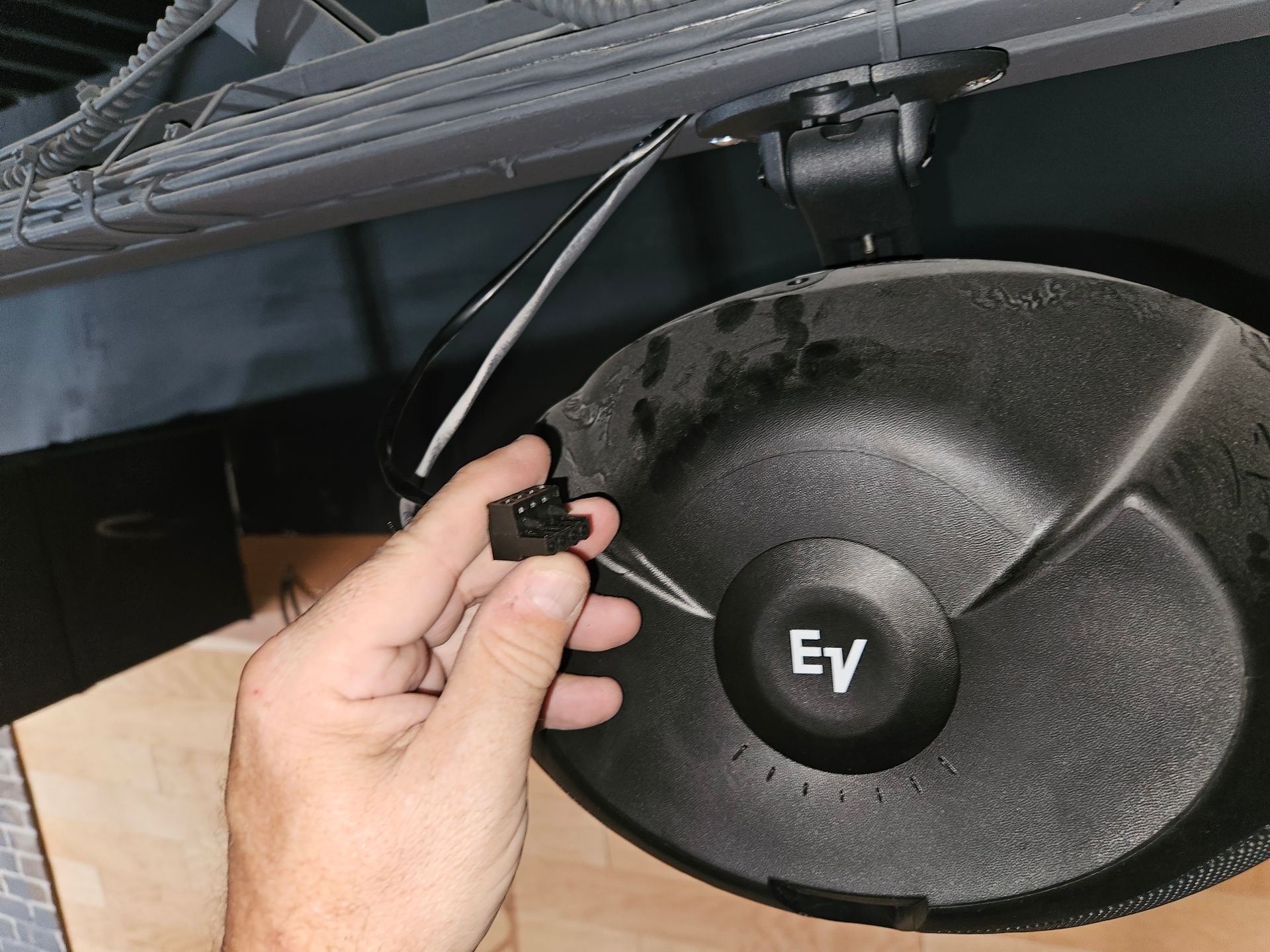 A person is holding a ey speaker in their hand