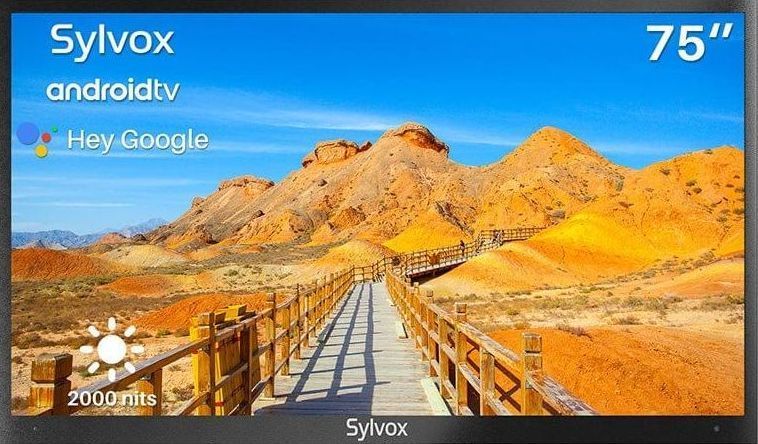 A 75 inch sylvania android tv with a wooden bridge in the desert
