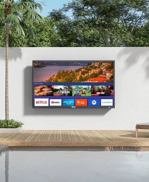 A flat screen tv is hanging on a wall next to a pool.