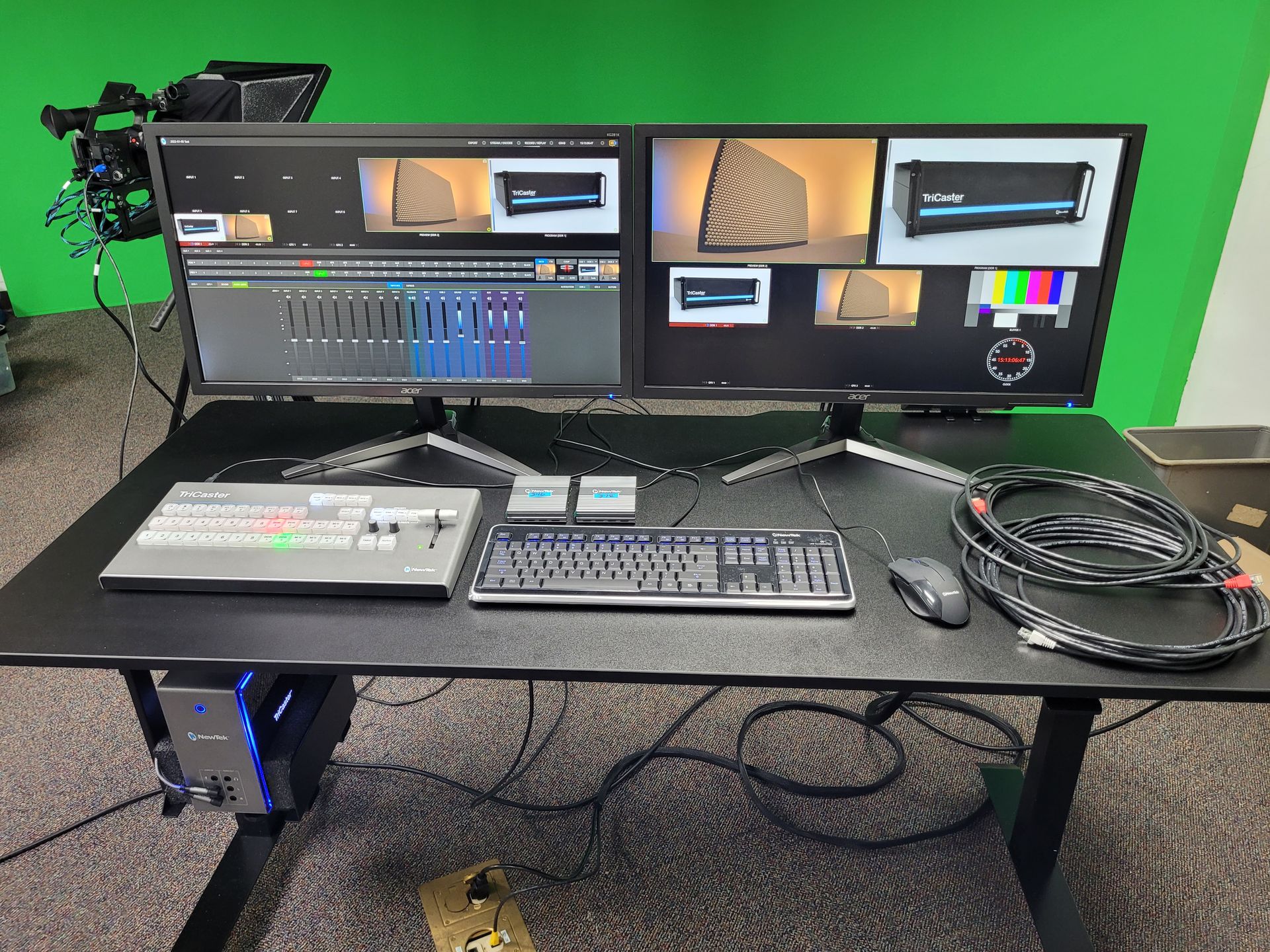 A desk with two monitors and a keyboard on it