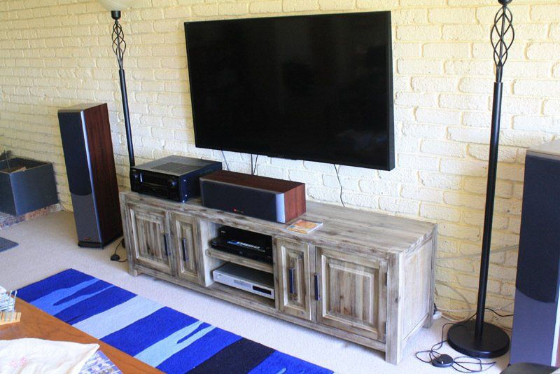 A living room with a flat screen tv and speakers