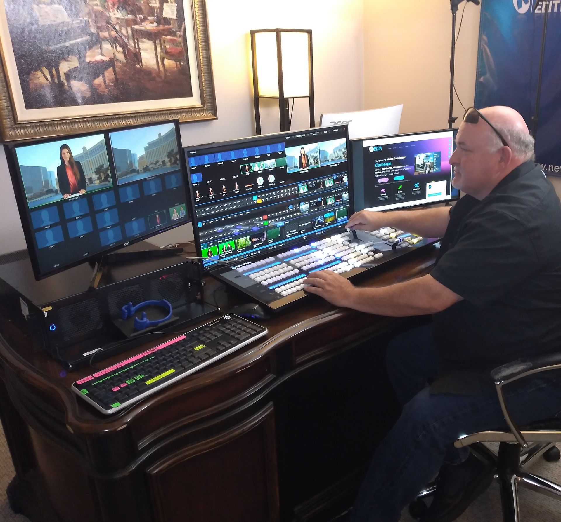 A man is sitting at a desk using a laptop computer