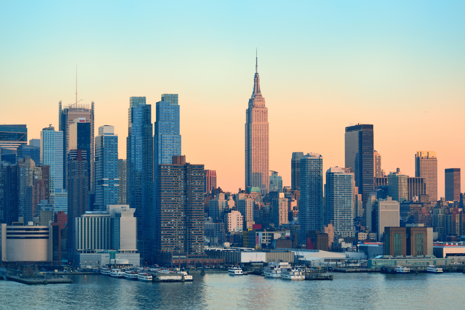 A city skyline with the empire state building in the foreground