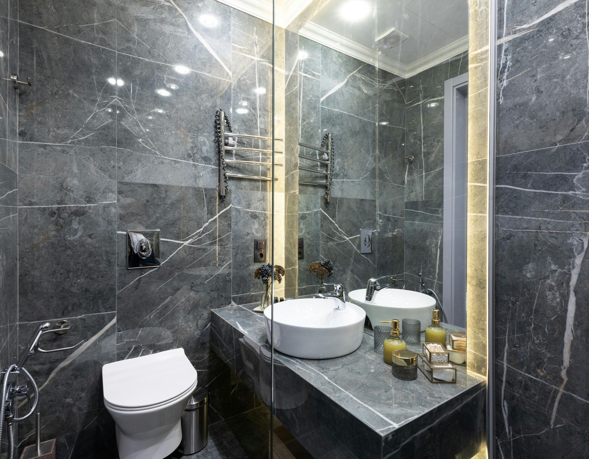 A bathroom with a toilet , sink , and mirror.