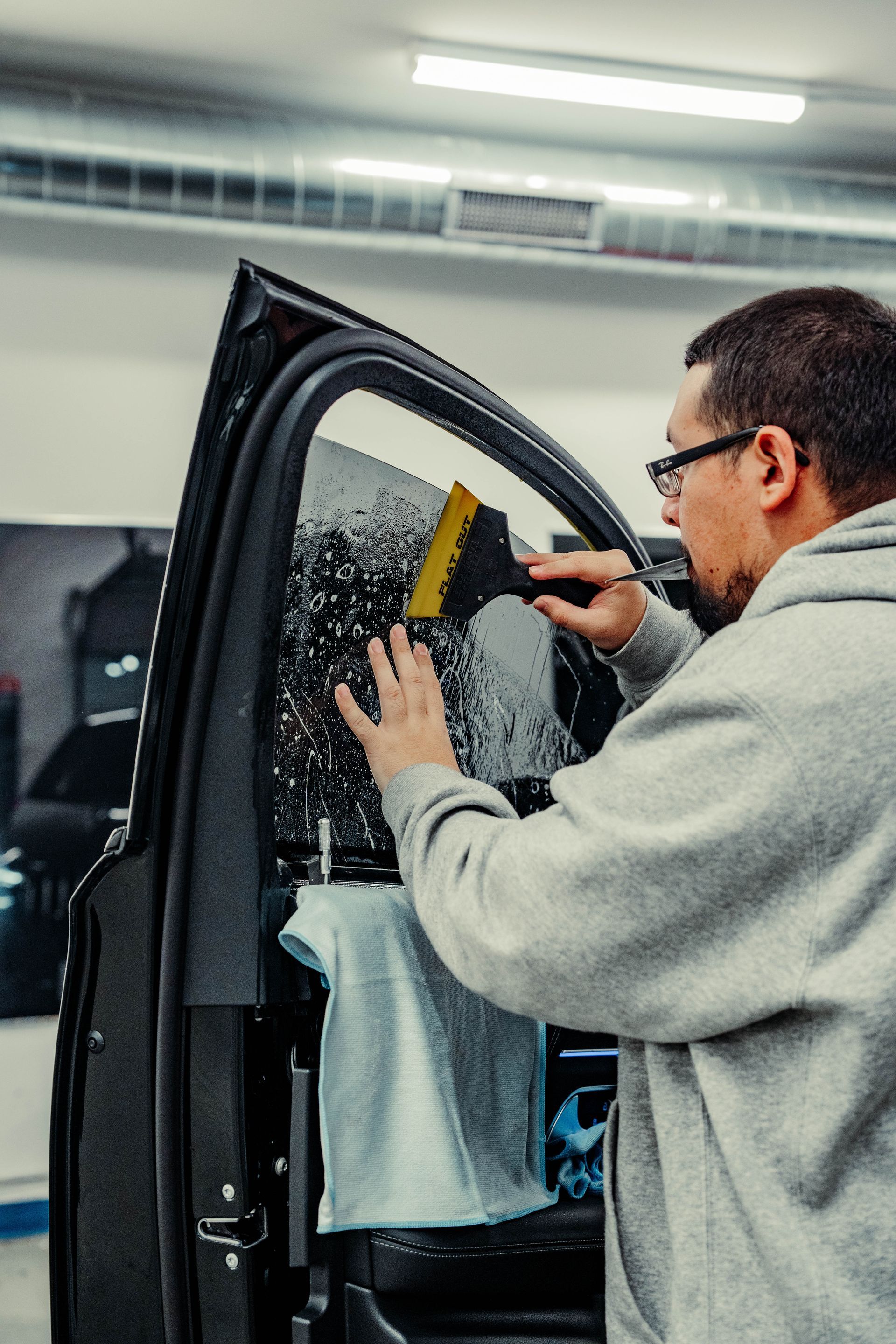 Ceramic window tint being installed by Chicago Auto Pros