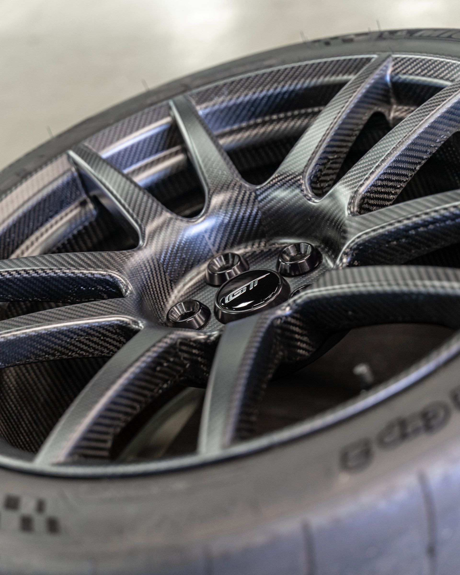 A close up of a car wheel with a tire on it