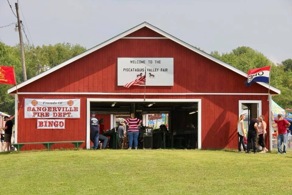 A red building with 'Sangerville Fire Dept. Bingo' signage, serving as a venue at the Piscataquis Valley Fair.
