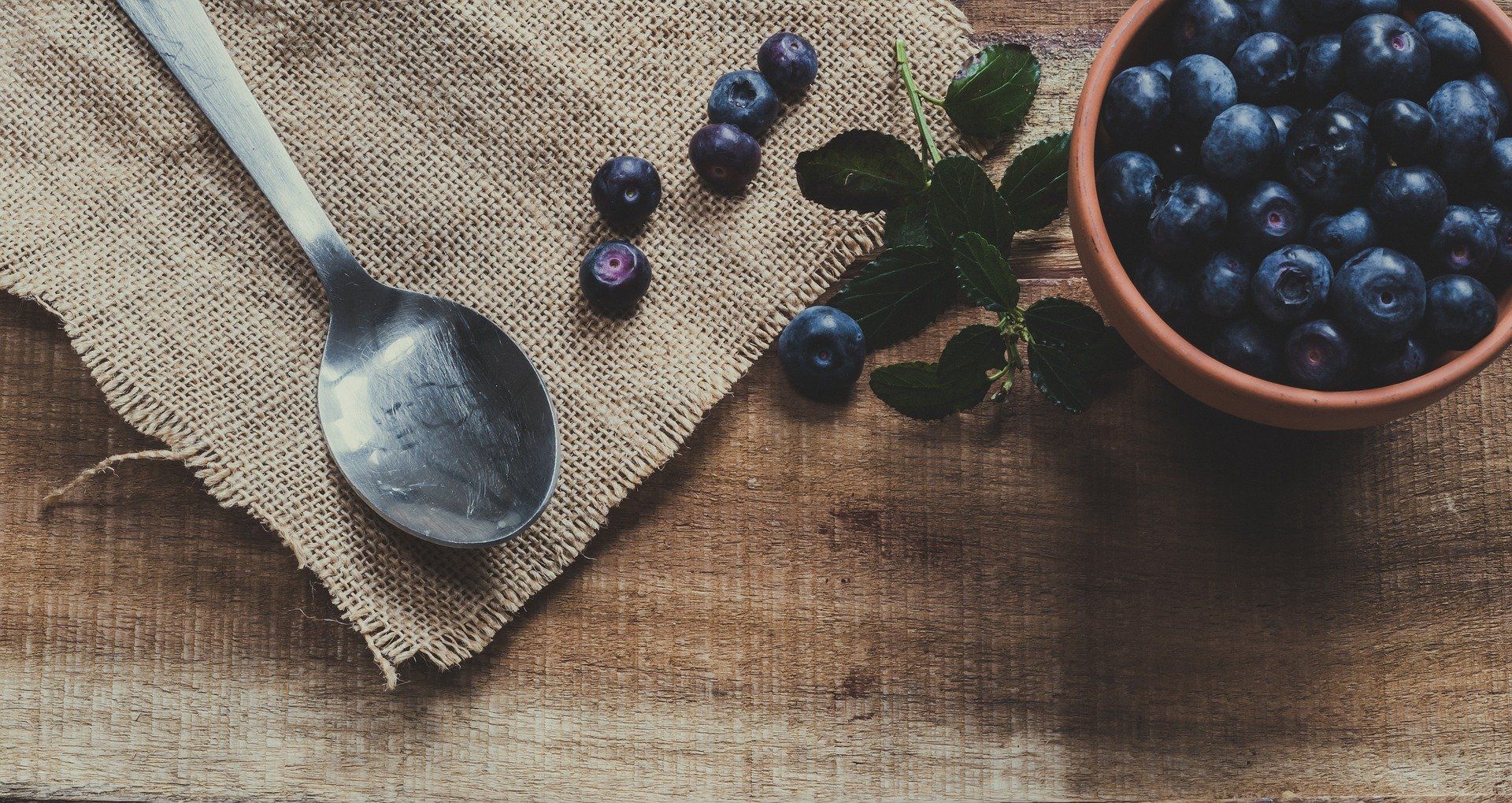 Beeren in und neben Schale mit Löffel