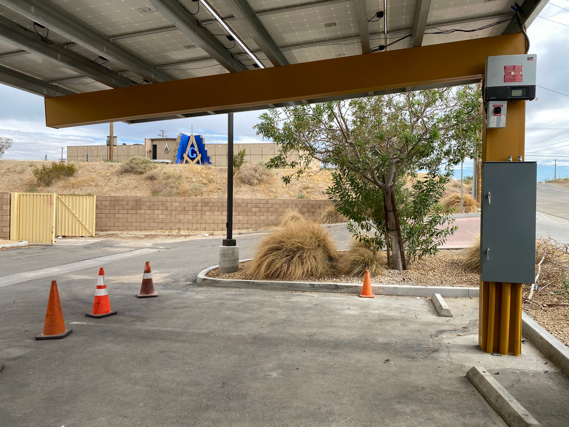 Covered outdoor area with traffic cones and a blue playground structure in the background