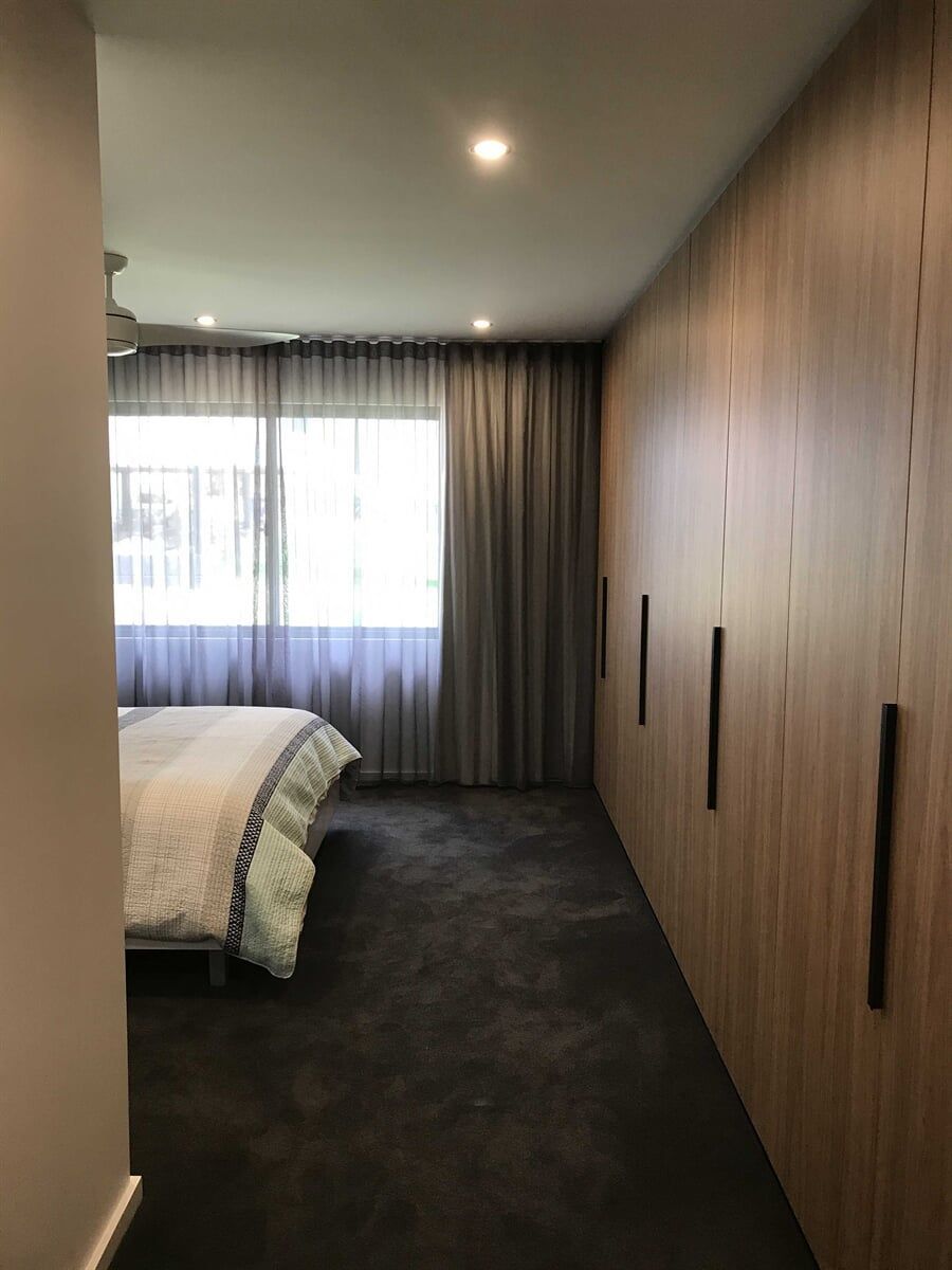 Spacious Wooden Cabinet Enhancing Bedroom Ambiance — Custom Cabinetry in Cessnock, NSW