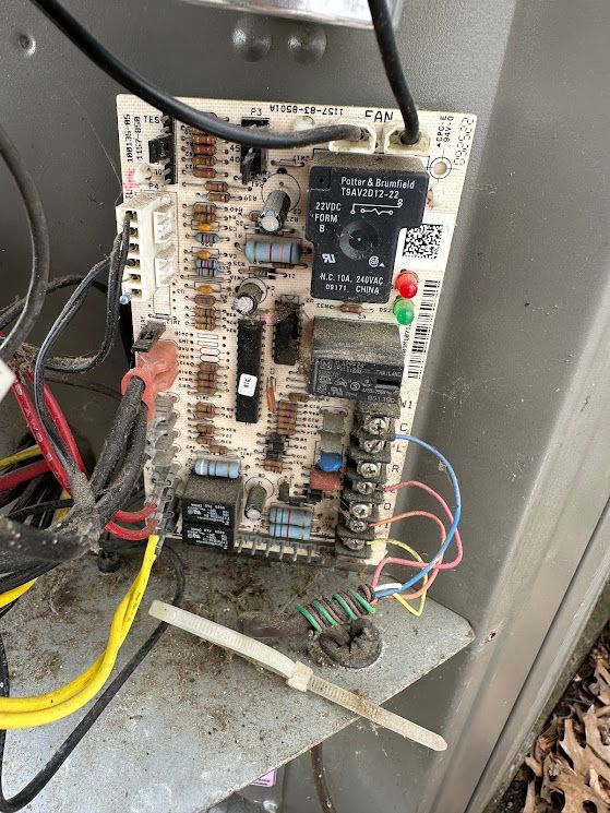 A close up of a circuit board with wires coming out of it.