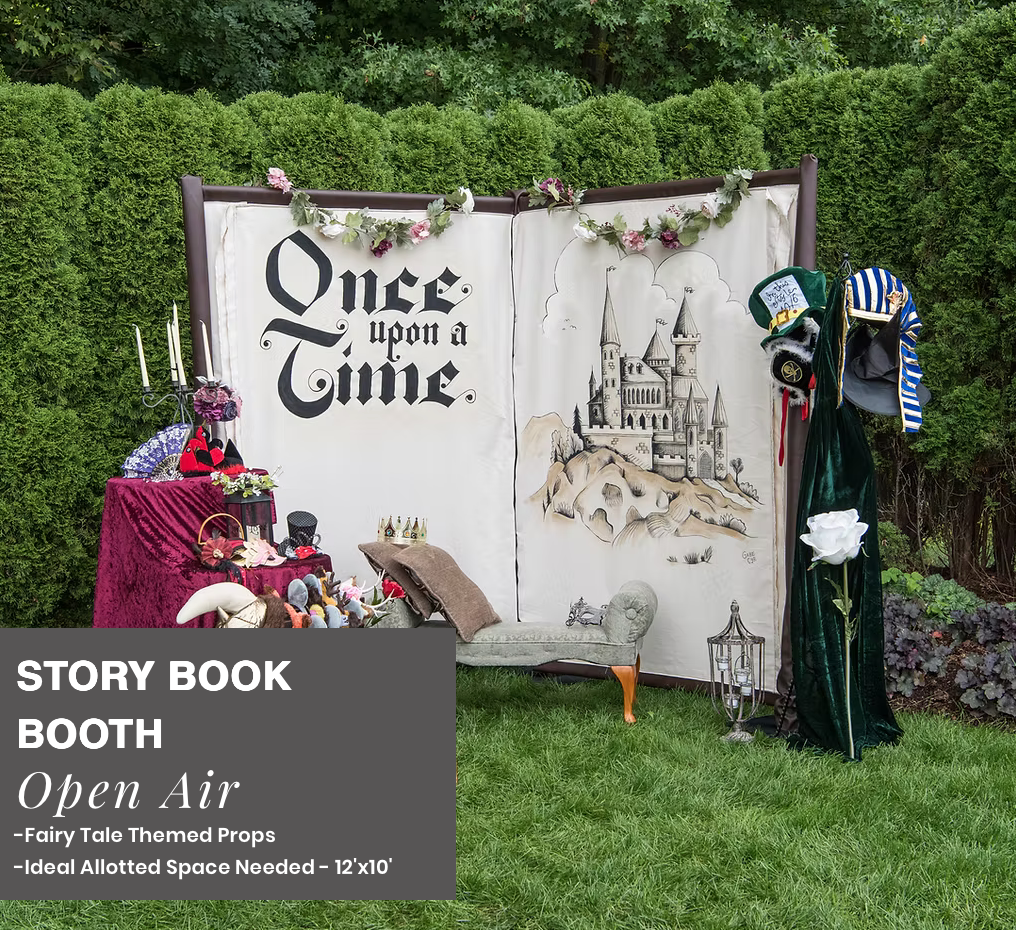 Storybook booth display with “Once upon a time” backdrop, castle sketch, and colorful props on grass