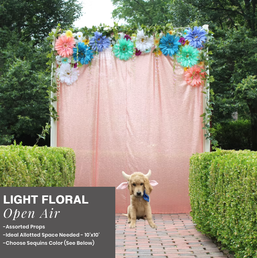 Small tan dog on a brick path before a pink floral backdrop outdoors