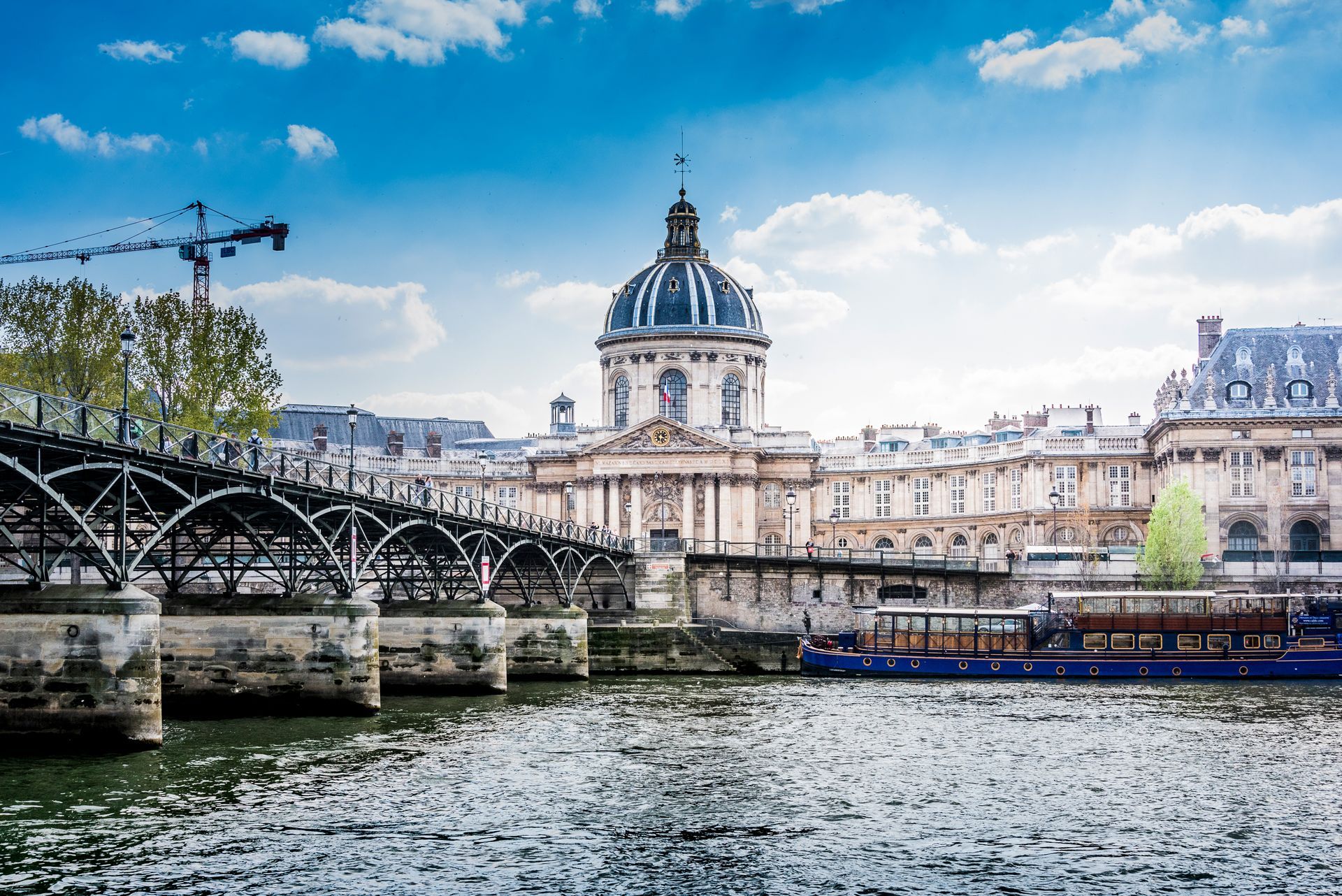 Pont des Arts over the Seine with the Institut de France in the background and a boat in the foreground. Brad Burgess Photography, Talking Excitingly