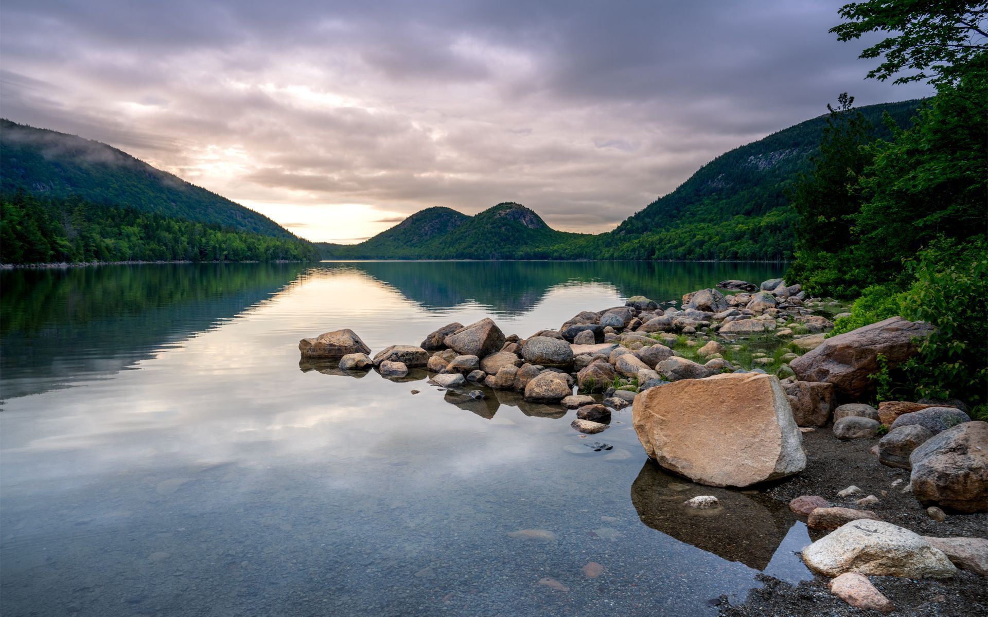 a lake with rocks on the shore and mountains in the background . Jordan Pond, Acadia National Park, Talking Excitingly, Brad Buress Photography