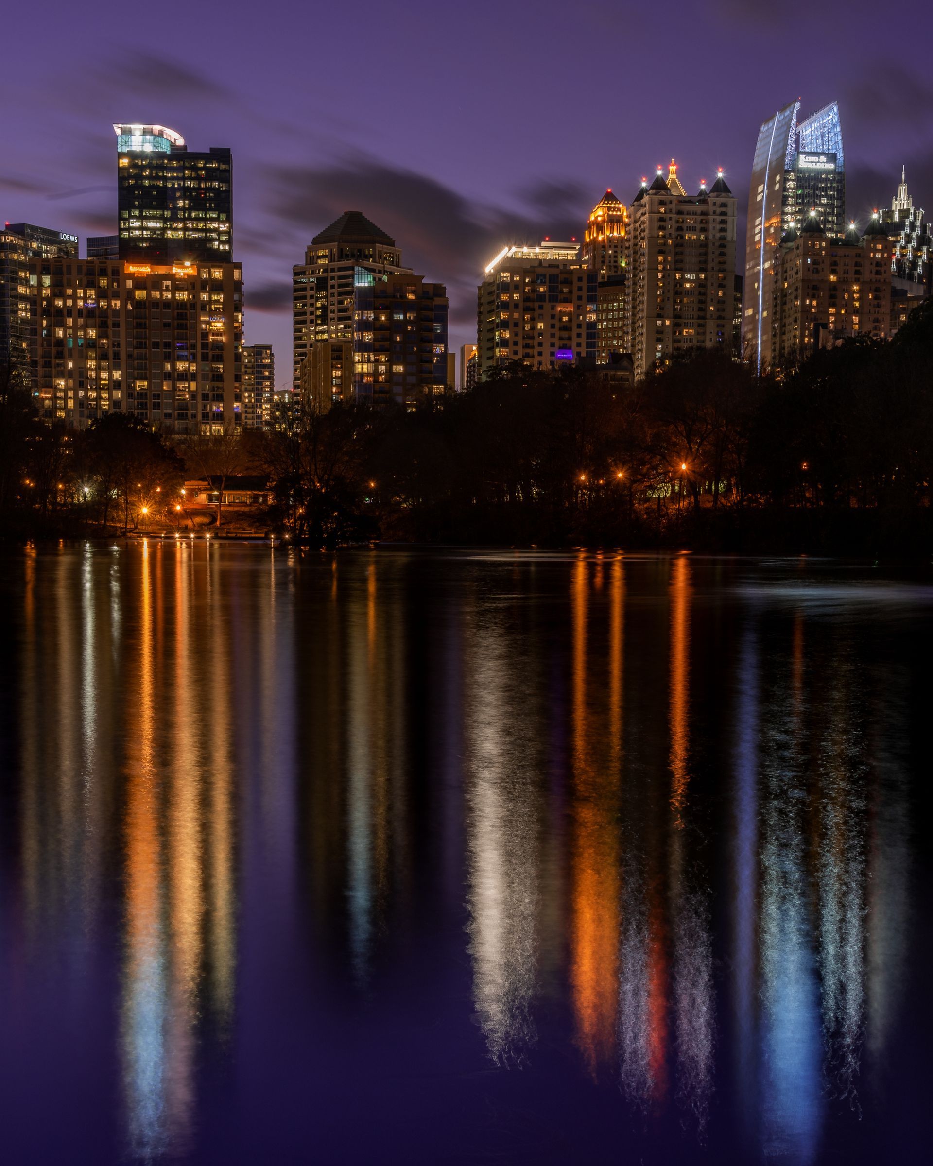 The Midtown Atlanta city skyline is reflected on Lake Clara Meer at night. Brad Burgess Photography, Talking Excitingly