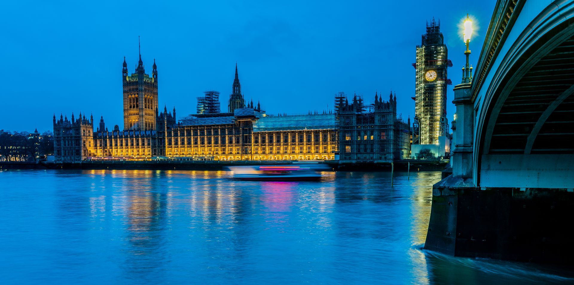 a boat is going under a bridge in london at night . Brad Burgess Photography, Talking Excitingly