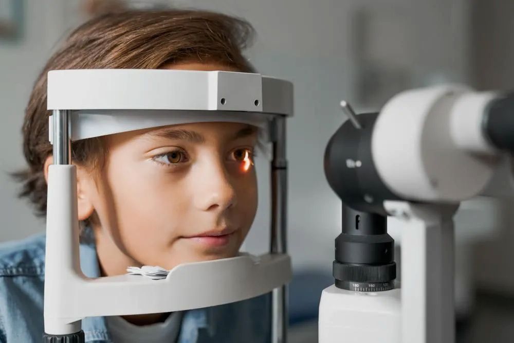 A Young Boy is Getting His Eyes Examined by an Ophthalmologist — Michael Chu Optometrist in Cairns North, QLD