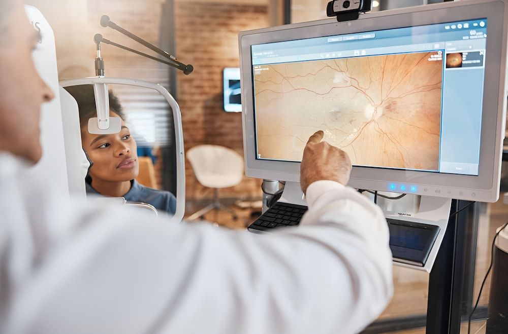 A Woman is Getting Her Eyes Checked by an Ophthalmologist  — Michael Chu Optometrist in Cairns North, QLD