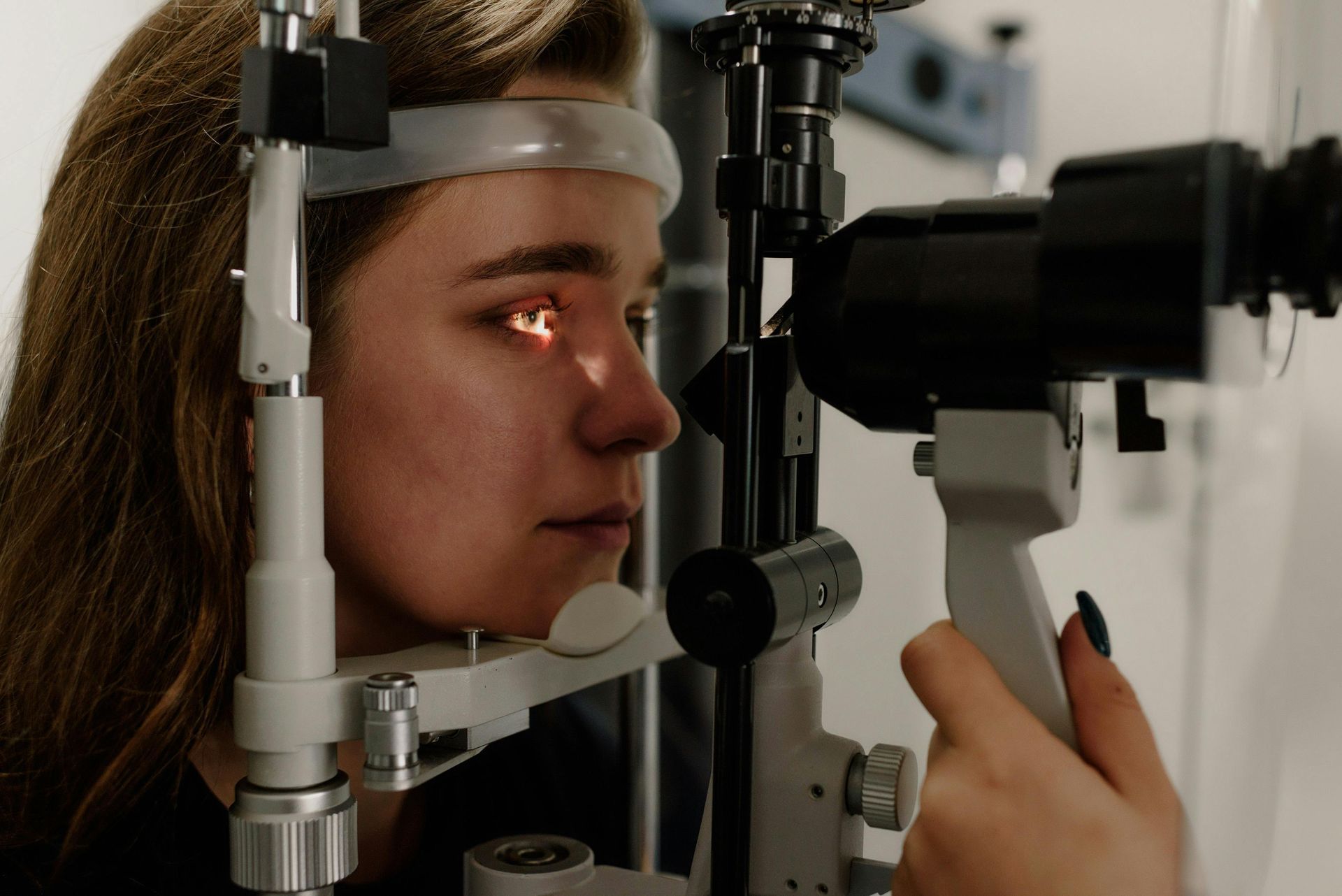 A Doctor is Examining a Man's Eye in a Hospital — Michael Chu Optometrist in Cairns North, QLD