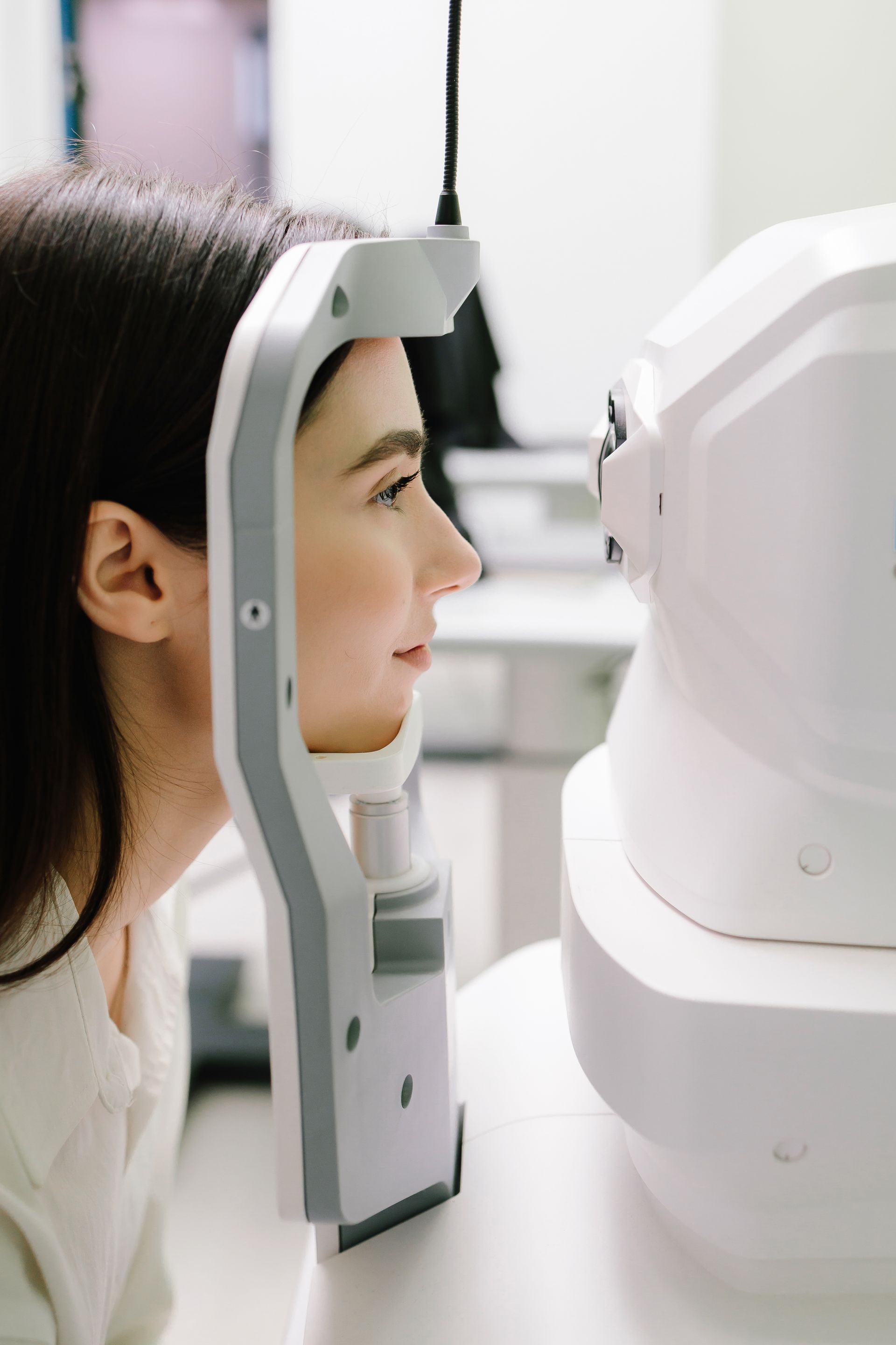 A Woman is Getting Her Eyes Checked by an Ophthalmologist — Michael Chu Optometrist in Cairns North, QLD