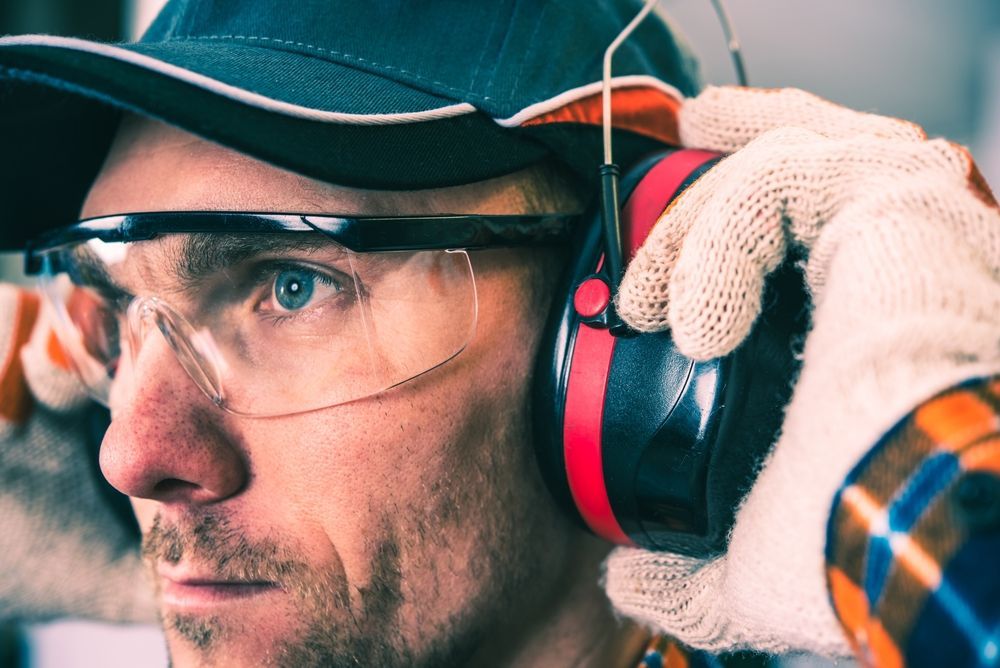 A Man Wearing Safety Glasses And Ear Muffs — Michael Chu Optometrist in Cairns North, QLD