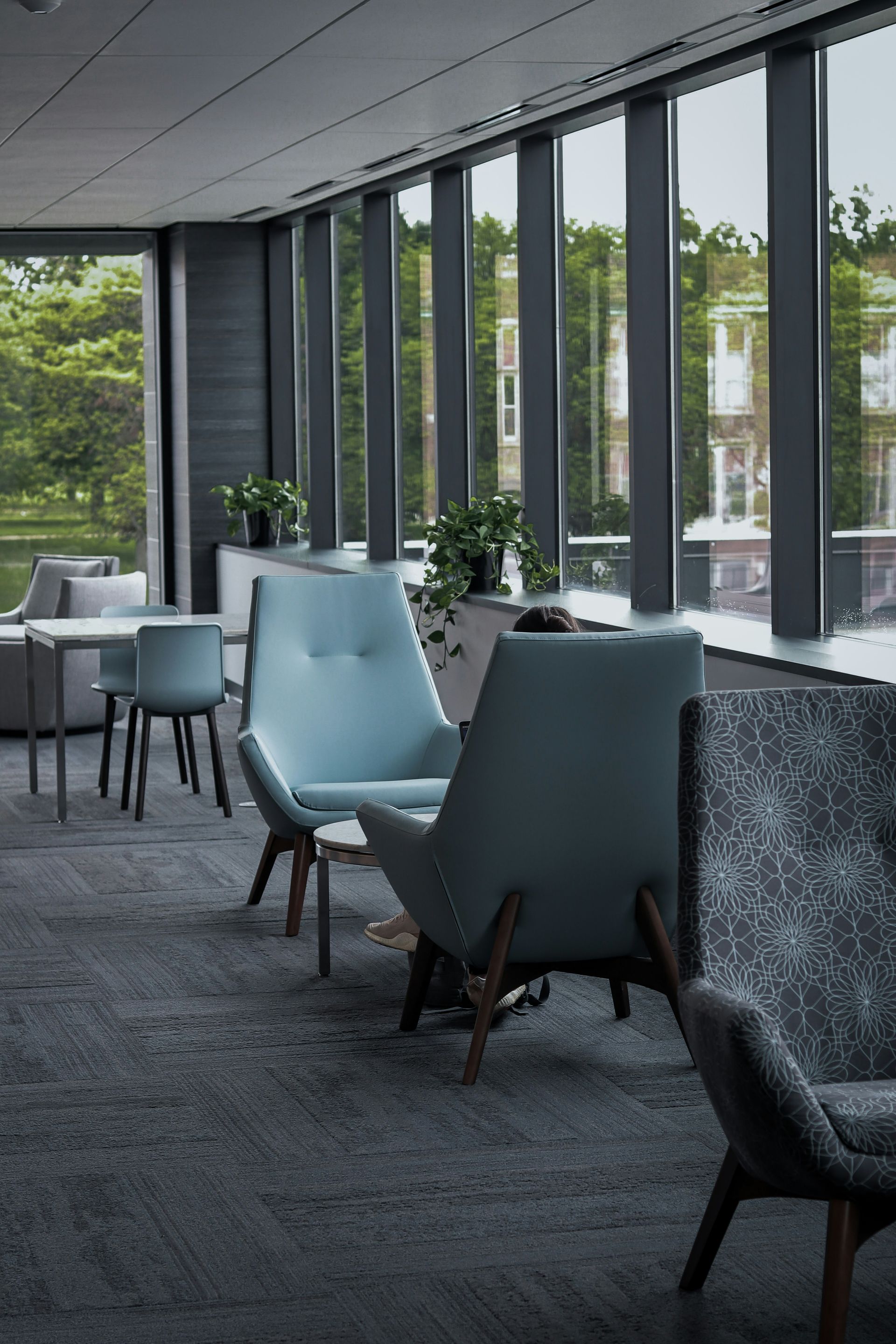 A room with a lot of windows and chairs in it