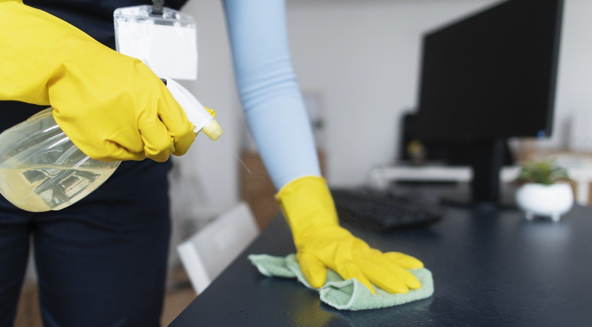 woman cleaning an office desk
