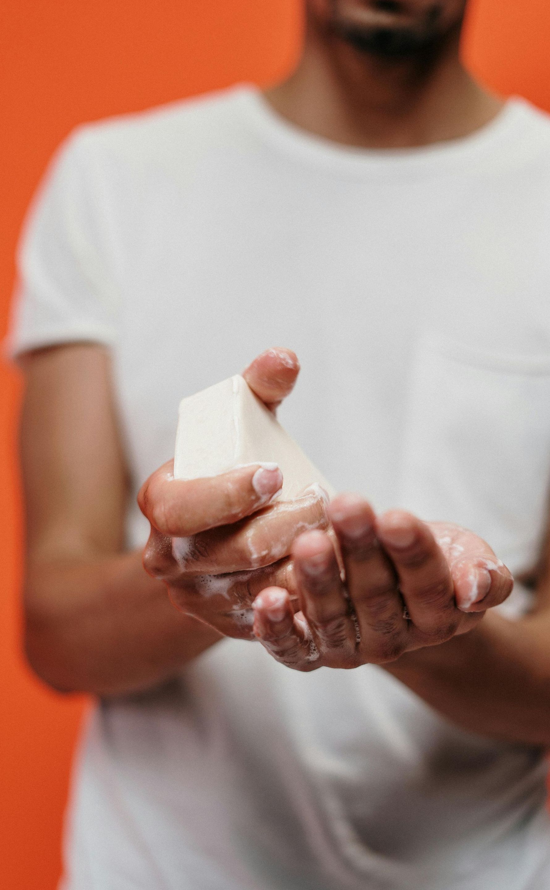 A man is washing his hands with soap.