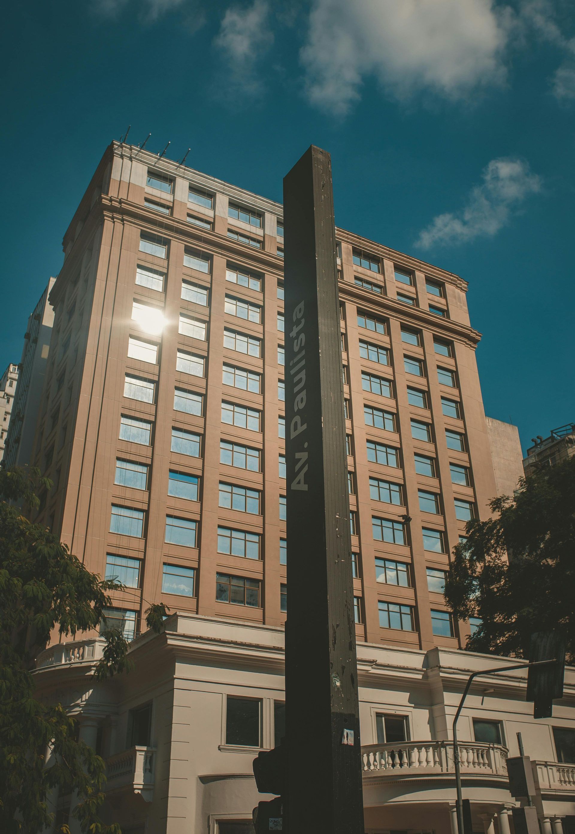 A tall building with a sign in front of it.