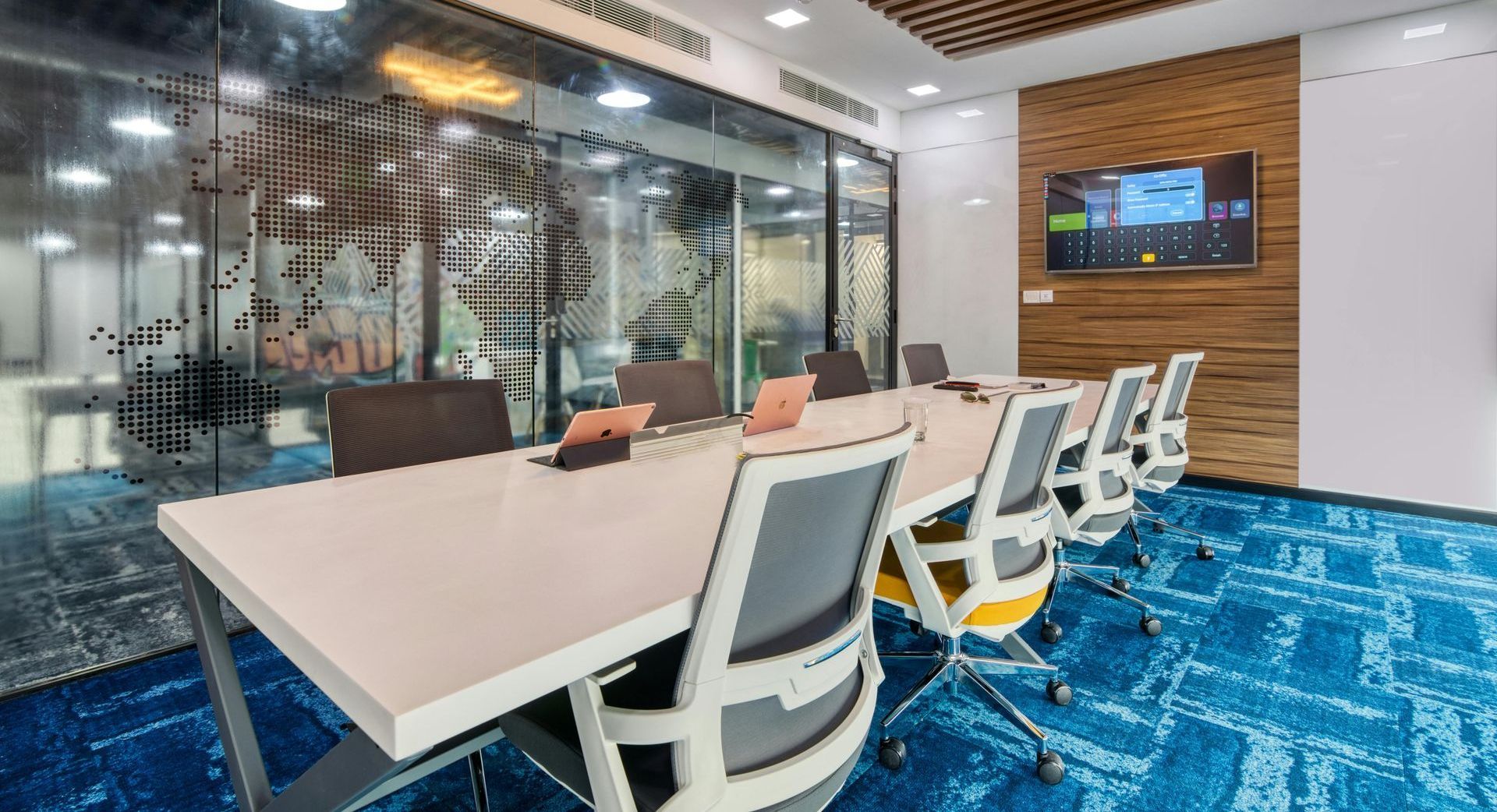 A conference room with a long table and chairs.