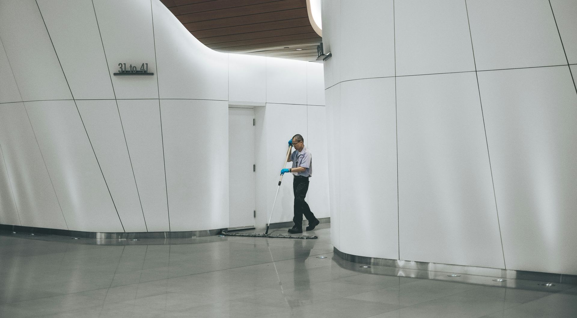 man cleaning an office floor