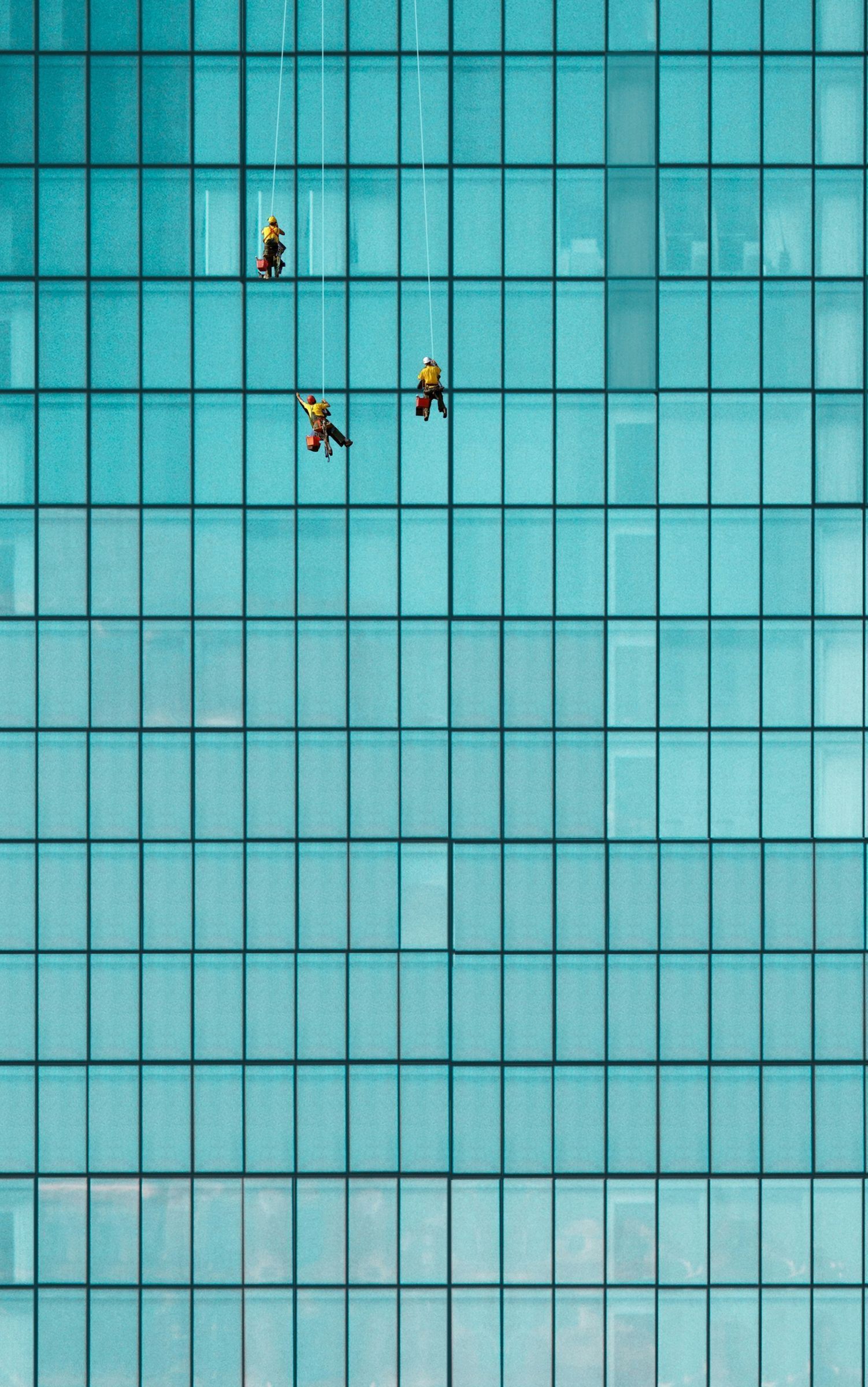 workers washing windows on an office building