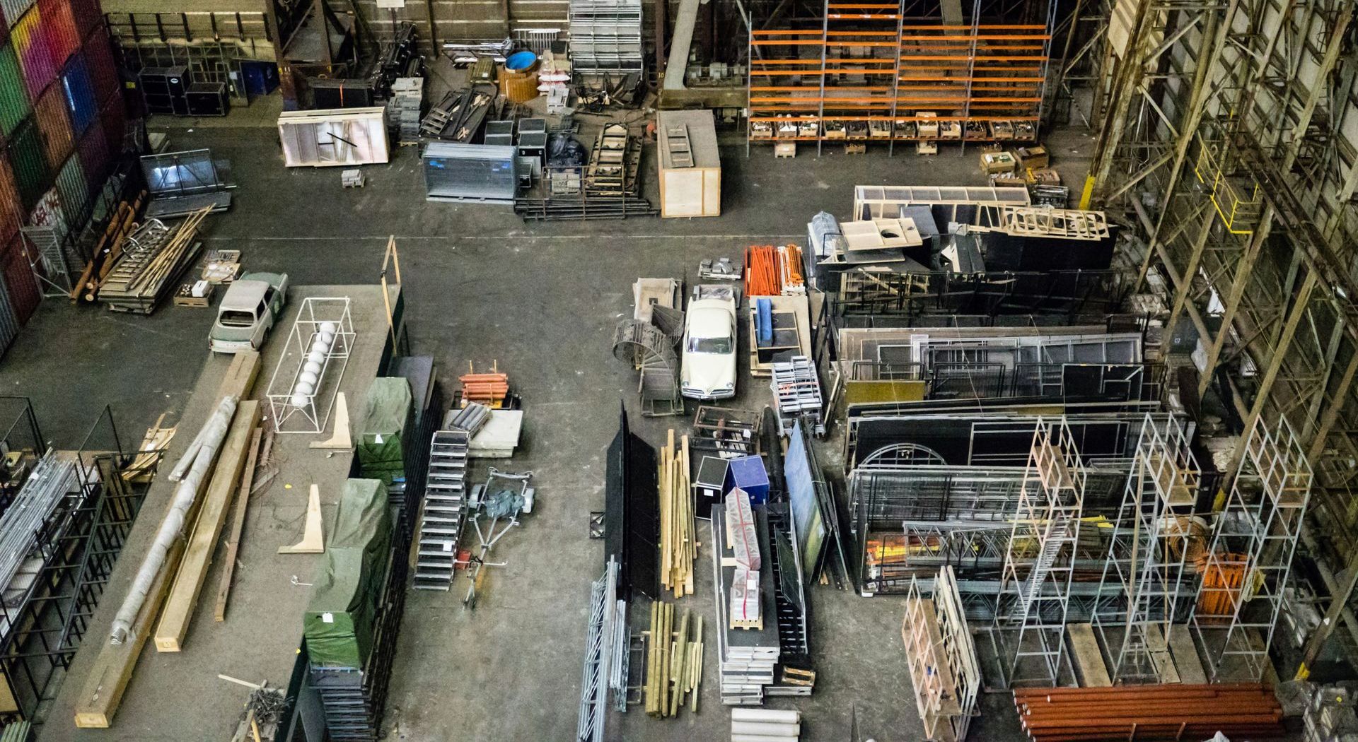 An aerial view of a large warehouse filled with lots of cargo.