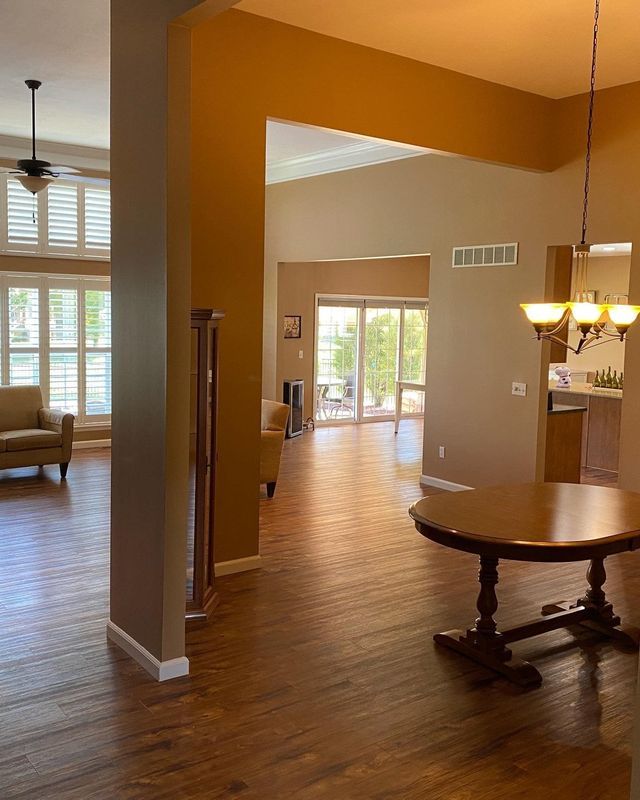 A living room with hardwood floors and a table