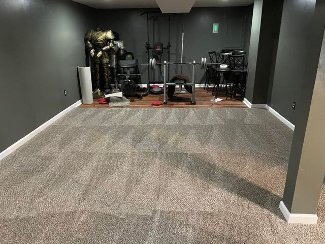 A basement with a statue of iron man on the wall