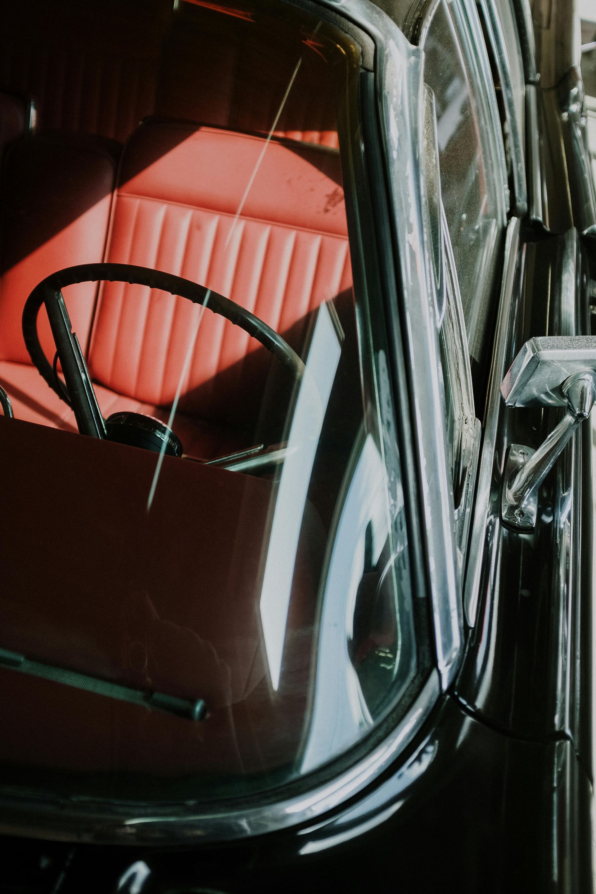 A black car with red seats and a steering wheel
