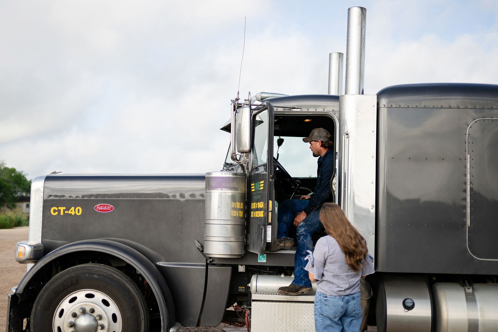 Open trailer packed with tires, tools, and equipment at a racetrack pit area