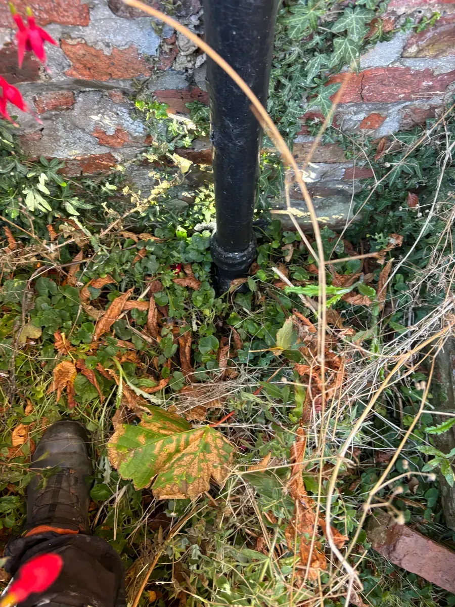 Two completely blocked rainwater downpipes were mechanically rodded and flushed to restore drainage.