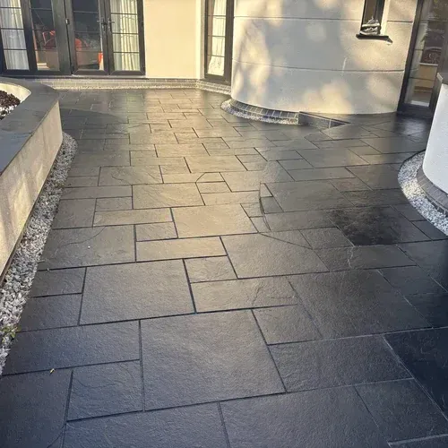 Clean black limestone patio after professional patio cleaning and restoration