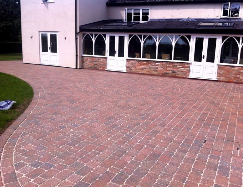 Red block paved driveway cleaned by us