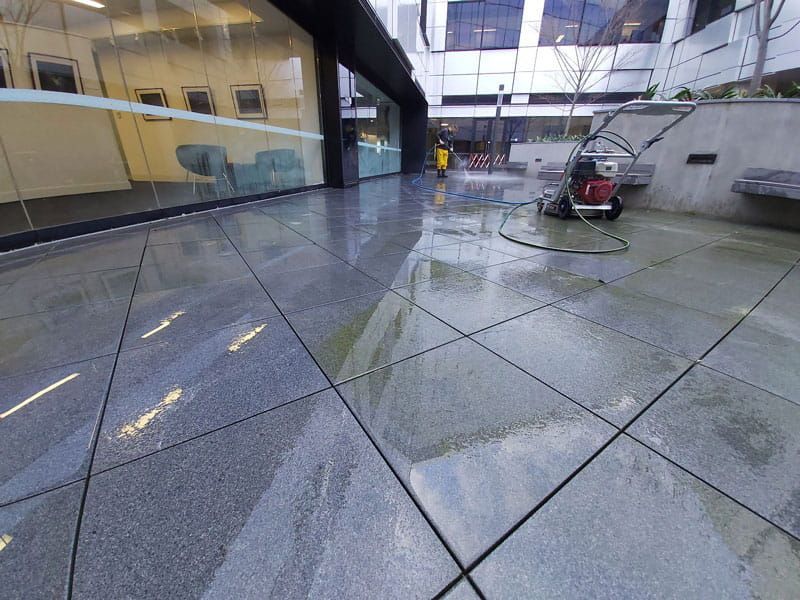 Pressure washing paved patio in Hull city center
